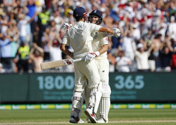 Congratulations: England's Alastair Cook celebrates  his century  with Joe Root. Picture: Jason O'Brien/PA