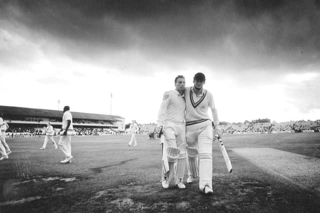 Black clouds overhead, but on the field this was one of Yorkshire's brightest moments as Martyn Moxon puts an arm round a drained Ashley Metcalfe after their record unbroken stand of 242 in the NatWest Trophy win over Warwickshire in 1990.