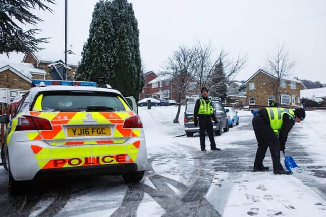 Police help residents clear snow from Vesper Lane in Leeds, West Yorks., after three accidents were reported in half an hour this morning. Picture: SWNS