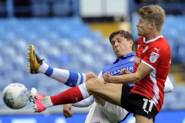 Back in action: Lloyd Isgrove challenges Sheffield Wednesday's Adam Reach. Picture: Steve Ells