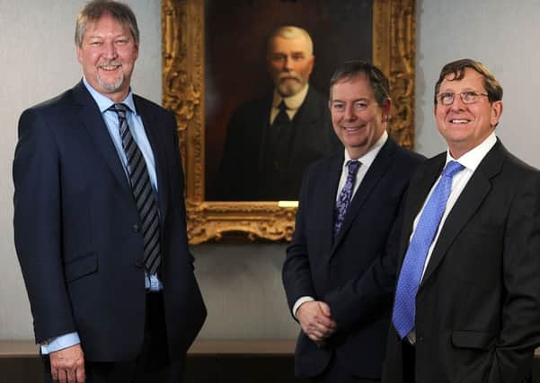 John Sutcliffe, chief executive of Henry Boot PLC, Simon Carr managing director of Henry Boot Construction, and Jamie Boot chairman of Henry Boot PLC, with a portrait of founder Henry Boot in the background. Picture Scott Merrylees.