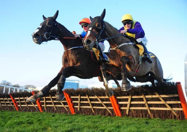 Mick Jazz and Davy Russell, left, on their way to winning the Ryanair Hurdle at Leopardstown (Picture: PA Wire).