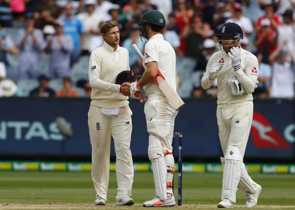THAT'S A WRAP: England's Joe Root shakes hands with Mitchell Marsh during day five at the MCG. Picture: Jason O'Brien/PA