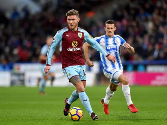 Burnley's Jeff Hendrick tries to find a way through the Huddersfield defence. Picture PA.