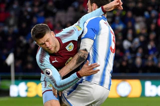 Huddersfield and Burnley battle for possession at the John Smith's Stadium. Picture: PA