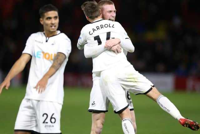 One that got away for Barnsley: Swansea City's Oliver McBurnie (back) celebrates with team-mate Tom Carroll after the Premier League win at Watford.