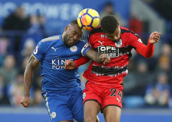 Leicester Citys Wes Morgan and Huddersfield Towns Steve Mounie, right, indulge in an aeriel duel for possession (Picture: Nigel French/PA Wire).