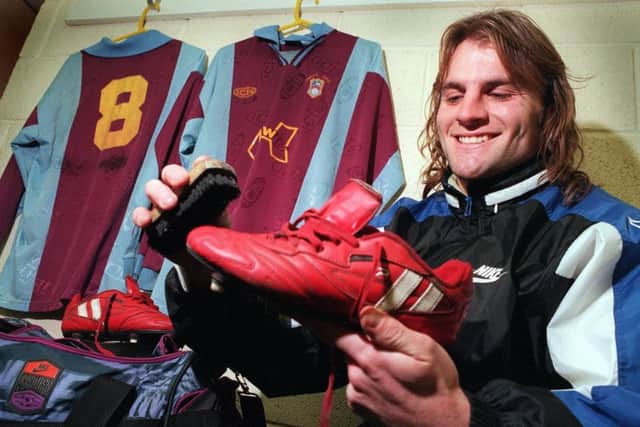 Emley's Mark Wilson prepares his lucky red boots for the 1998 FA Cup tie with West Ham.