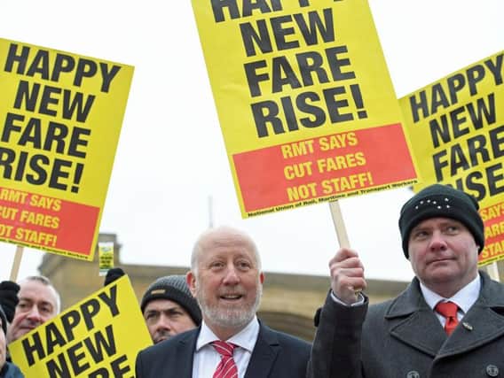 Shadow Transport Secretary Andy McDonald (centre) joins campaigners protesting against rail fare increases outside King's Cross station in London, before he set off for Leeds. PRESS ASSOCIATION Photo. Stefan Rousseau/PA Wire