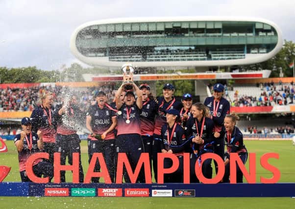 Champions: England's Heather Knight lifts the trophy after the ICC Women's World Cup final.