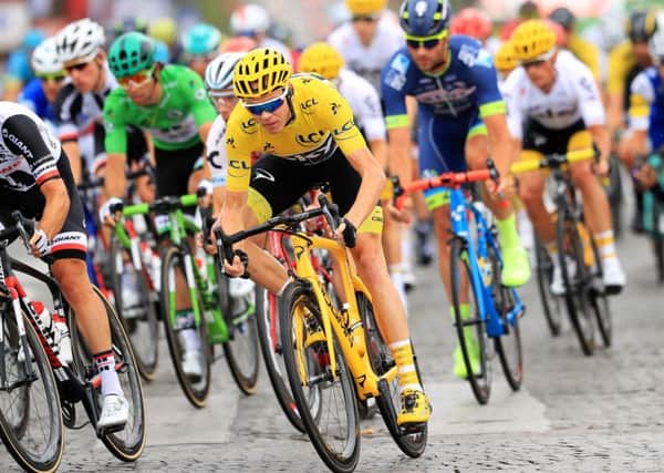 TAINTED: Chris Froome rides on the Champs-Elysees in the Tour de France leader's yellow jersey in 2017. Picture: Adam Davy/PA