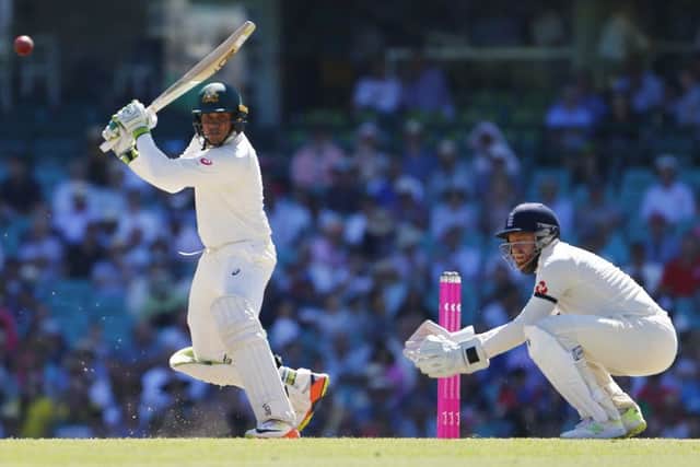 Australia's Usman Khawaja hits a shot as Jonny Bairstow looks on during day two of the Ashes Test match at Sydney Cricket Ground. (Picture: Jason O'Brien/PA Wire)