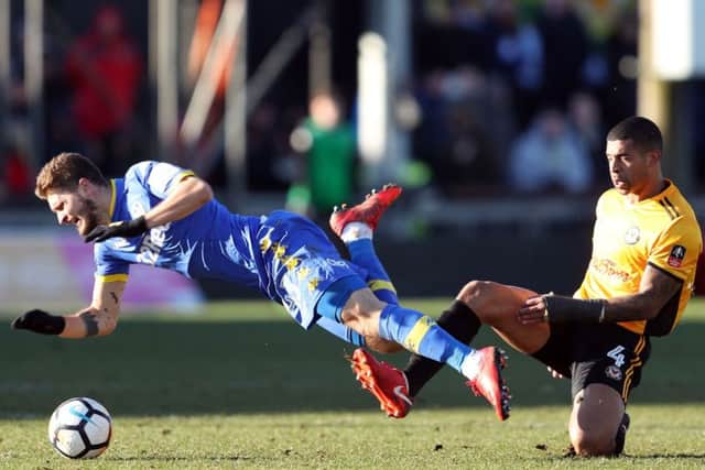 TOUGH DAY: Leeds United's Mateusz Klich (left) is tackled by Newport County's Joss Labadie at Rodney Parade, Newport. PRESS ASSOCIATION Photo. Picture: David Davies/PA