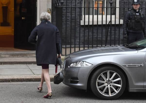 Theresa May arrives at 10 Downing Street to begin her reshuffle.