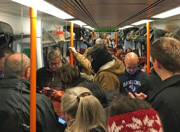 Commuters ride a crowded South Western Railway train on the Portsmouth to London Waterloo line as workers in five rail companies stage a fresh wave of strikes in the bitter disputes over the role of guards