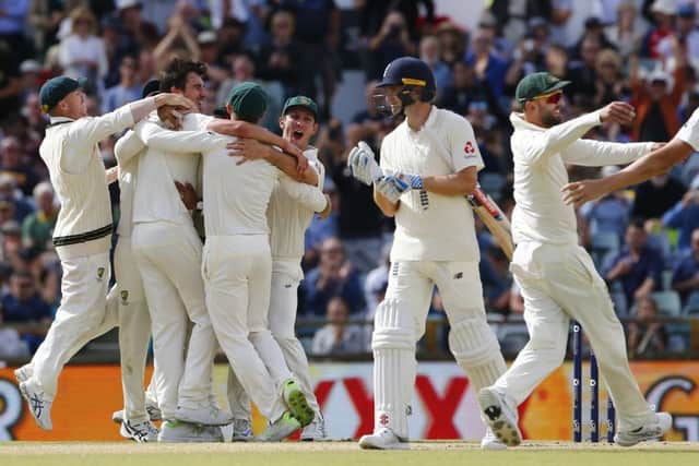 MOMENT OF TRUTH: Australia celebrate the final wicket of Chris Woakes to clinch the Ashes series on the third Test match at the WACA in Perth. Picture: Jason O'Brien/PA