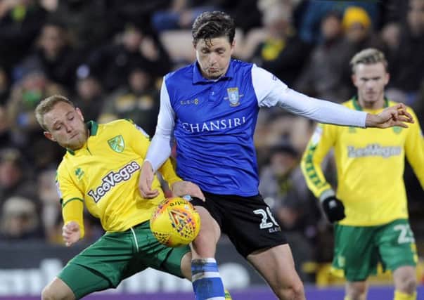Norwich City's Alex Pritchard, left, seen in a challenge with Sheffield Wednesday's Adam Reach (Picture: Steve Ellis).