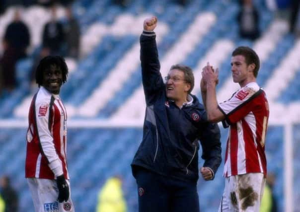 Double triumph: Sheffield United manager Neil Warnock celebrates at full time with scorers Ade Akinbiyi and Michael Tonge.
