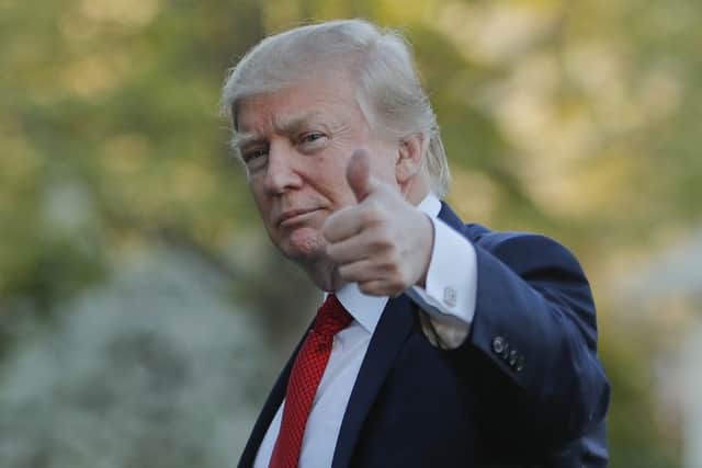 DAY 80 - In this April 9, 2017, file photo, President Donald Trump gives a thumbs-up as he walks across the South Lawn of the White House in Washington, as he returns from a trip to his Mar-a-Lago estate in Palm Beach, Fla. (AP Photo/Pablo Martinez Monsivais, File)