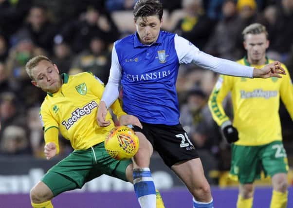 Sheffield Wednesday's Adam Reach competes with Norwich City's Alex Pritchard.