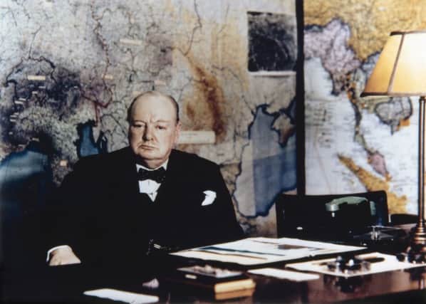 Winston Chrchill seated at his desk in the No 10 Annexe Map Room, May 1945.