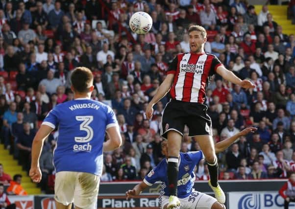 Chris Basham rises to head in a goal for Sheffield United against Ipswich Town.