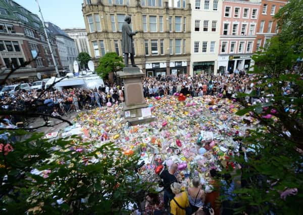 Floral tributes to remember the victims of the terror attack after last May's Manchester Arena bombing. Picture by Ben Birchall/PA Wire.