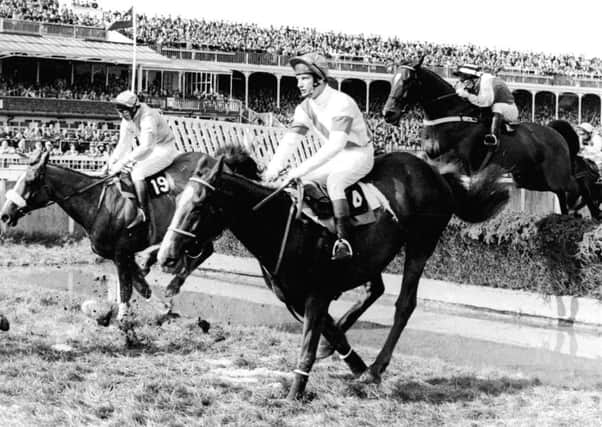 Bob Champion and Aldaniti clear the water jump in the 1981 Grand National.