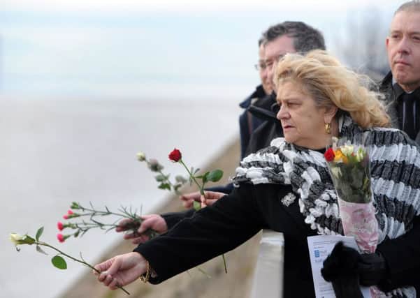 A previous Lost Trawlermen's Day, Hull.
 Pictured Jill Long throws her floral tributes into the Humber after the service.
Picture by Gerard Binks.