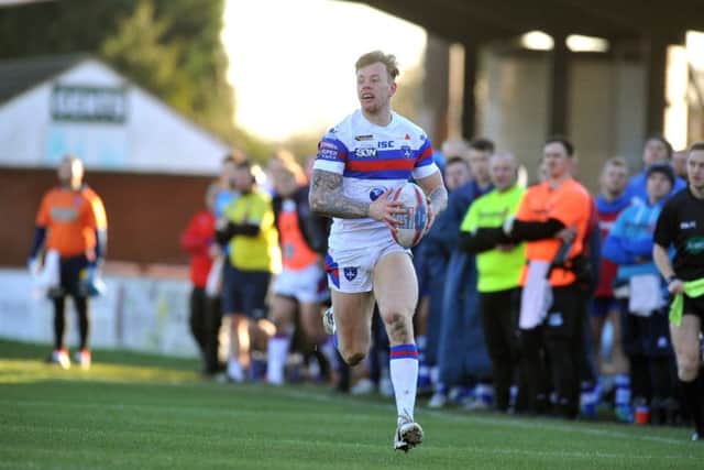 Wakefield winger Tom Johnstone on his way to a hat-trick of tries against Halifax last weekend