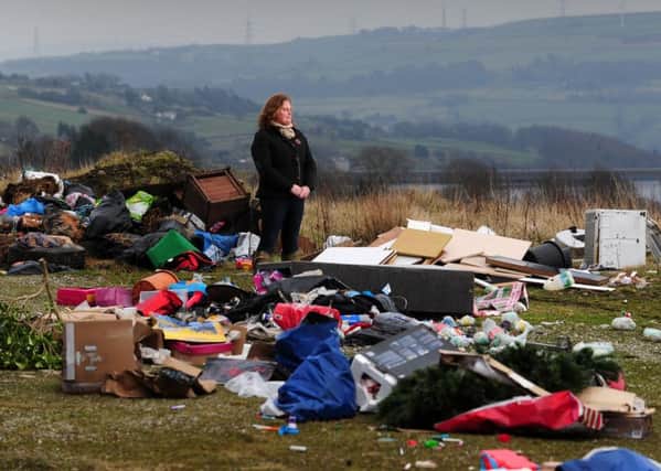 Rachel Hallos pictured amongst the mess left by flytippers alongside Beeston Hall Farm in Ripponden. Pictures by Simon Hulme.