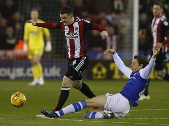 Sheffield United's John Fleck is tackled by Sheffield Wednesday's Adam Reach. Picture: Andrew Yates/Sportimage