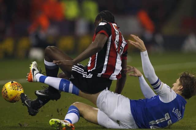 Clayton Donaldson is taken from behind by Glenn Loovens. Picture: Bruce Rollinson