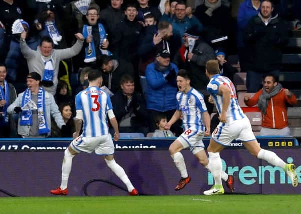 Huddersfield Town's Joe Lolley (centre) celebrates scoring his side's first goal.
