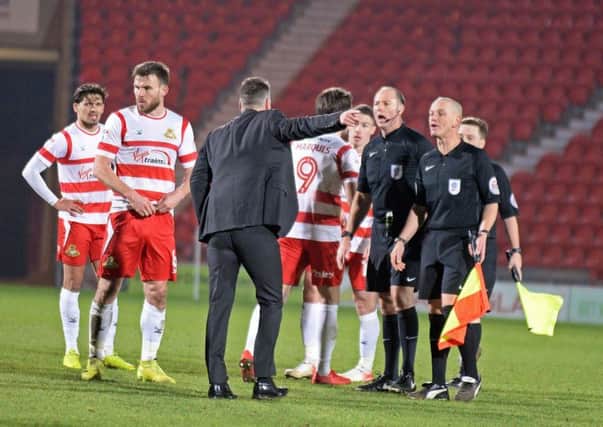 Fury: Darren Ferguson confronts the officials after the game. Picture: Marie Caley