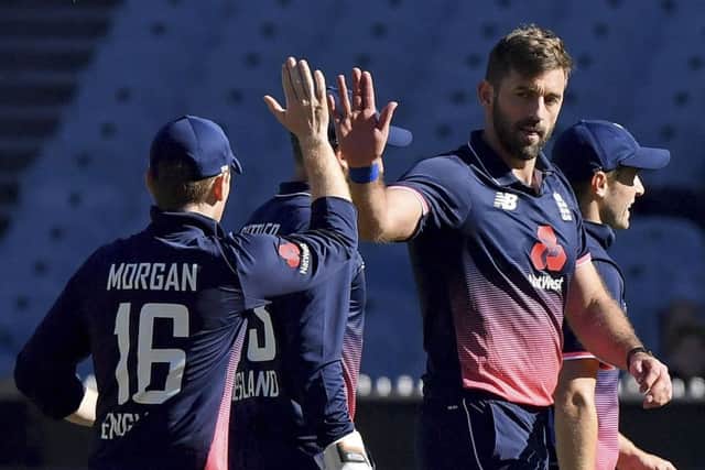 Yorkshire and England's Liam Plunkett, right, is congratulated by captain England's Eoin Morgan after capturing the wicket of Australia's Tim Paine  one of three he took in the game.