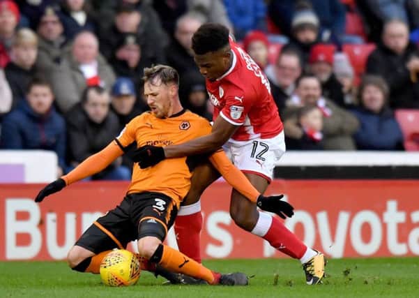 Wolverhampton Wanderers' Barry Douglas (left) and Barnsley's Dimitri Cavare compete for possession during the Sky Bet Championship match at Oakwell, Barnsley. (Pictures: Anthony Devlin/PA Wire)