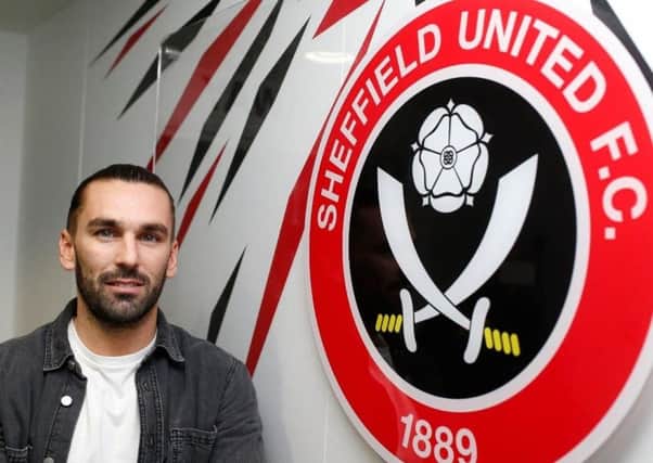 Ricky Holmes: Completed move to Sheffield United.