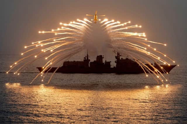 A Royal Navy Lynx helicopter producing a spectacular display with its decoy flares.