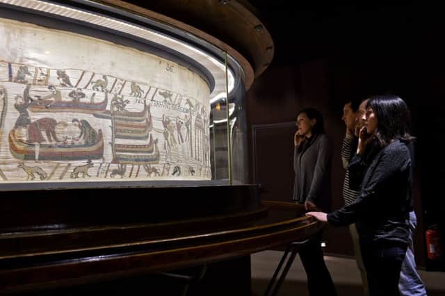 Visitors watching a section from the Bayeux tapestry. French officials are considering loaning the historic 70-meter-long Bayeux Tapestry to Britain for the first time.