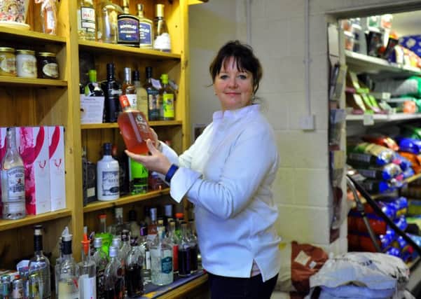Jo Barnes stcoking up the gin selection at The Mile Farm Shop. Picture by Gary Longbottom.