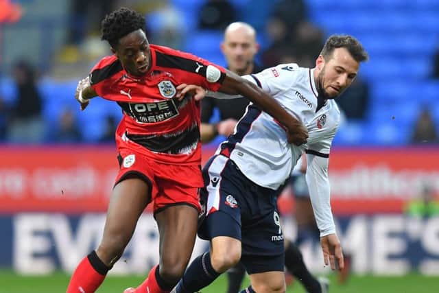 Huddersfield Town's Terence Kongolo battles with Bolton Wanderers' Adam Le Fondre during the FA Cup, third round match at the Macron Stadium, Bolton. (Picture: Dave Howarth/PA Wire)