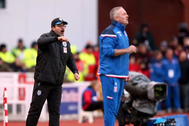 Huddersfield Town manager David Wagner (left) tries to get his instructions across to his players at the Britannia Stadium. Picture: Nigel French/PA