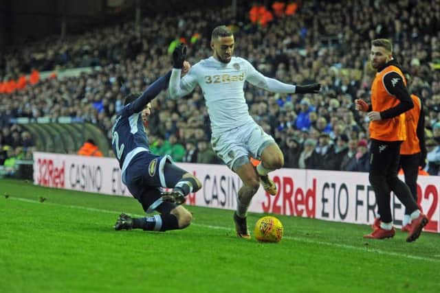 DOWN THE LINE: Leeds United's Leeds Kemar Roofe is tackled by Millwall's Conor McLaughlin. Picture: Tony Johnson.