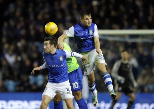 Sheffield Wednesday debutant Jordan Thornley in the thick of the action against Cardiff City. Picture: Steve Ellis