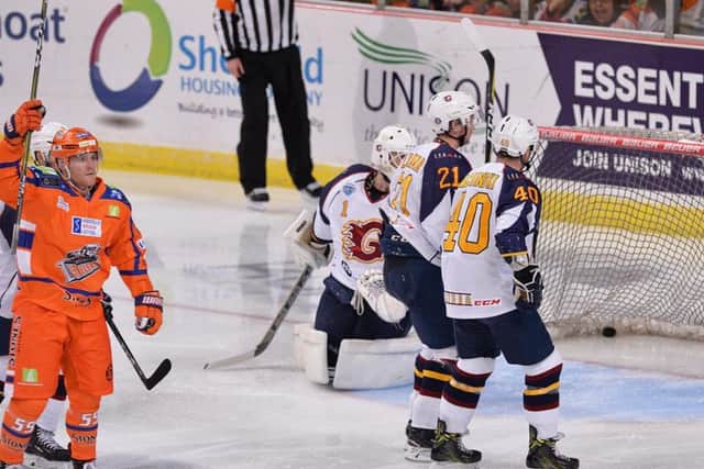 OPENING SALVO: Sheffield Steelers' Eric Neiley, far left, celebrates his third-minute goal against Guildford, the American forward finishing with a three-point night after adding two assists in the third period. Picture: Dean Woolley.