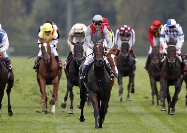 Treve, centre, ridden by Thierry Jarnet and trained by Criquette Head-Maarek, wins the first of her two Arcs in 2013.