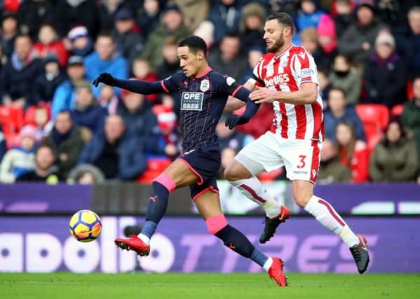 Huddersfield Town's Tom Ince, left, and Stoke City's Erik Pieters battle for the ball (Picture: Nigel French/PA Wire).