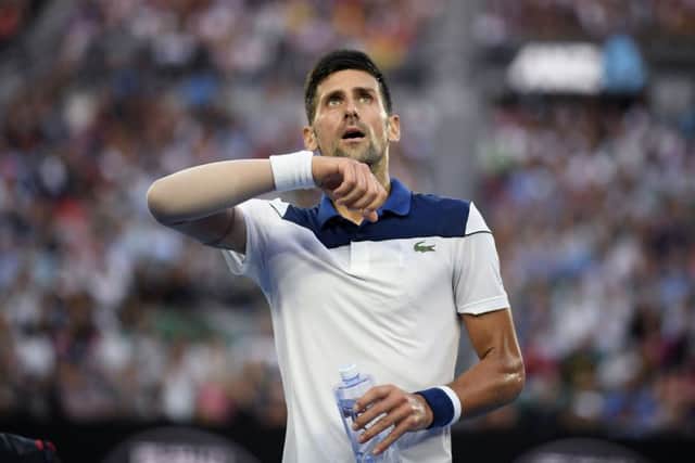 GOING OUT: Novak Djokovic contemplates defeat in Melbourne. Picture: AP/Andy Brownbill