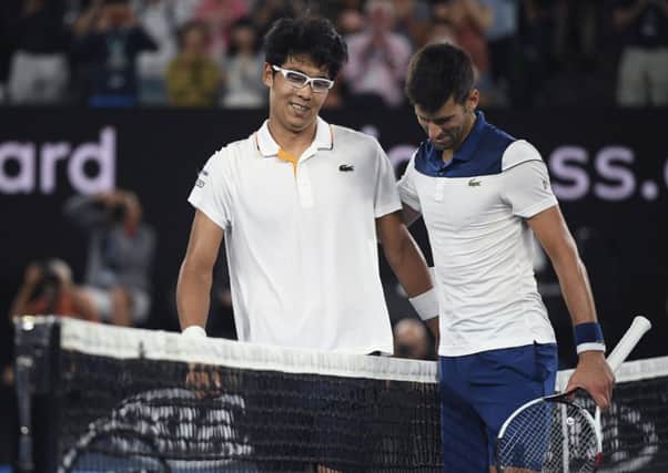 South Korea's Chung Hyeon, left, is congratulated by Serbia's Novak Djokovic. Picture: AP/Andy Brownbill